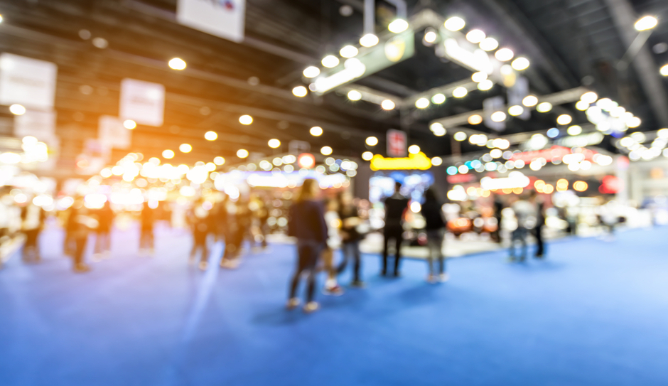 bustling trade show floor with professionals engaging in conversations and exchanging digital business cards